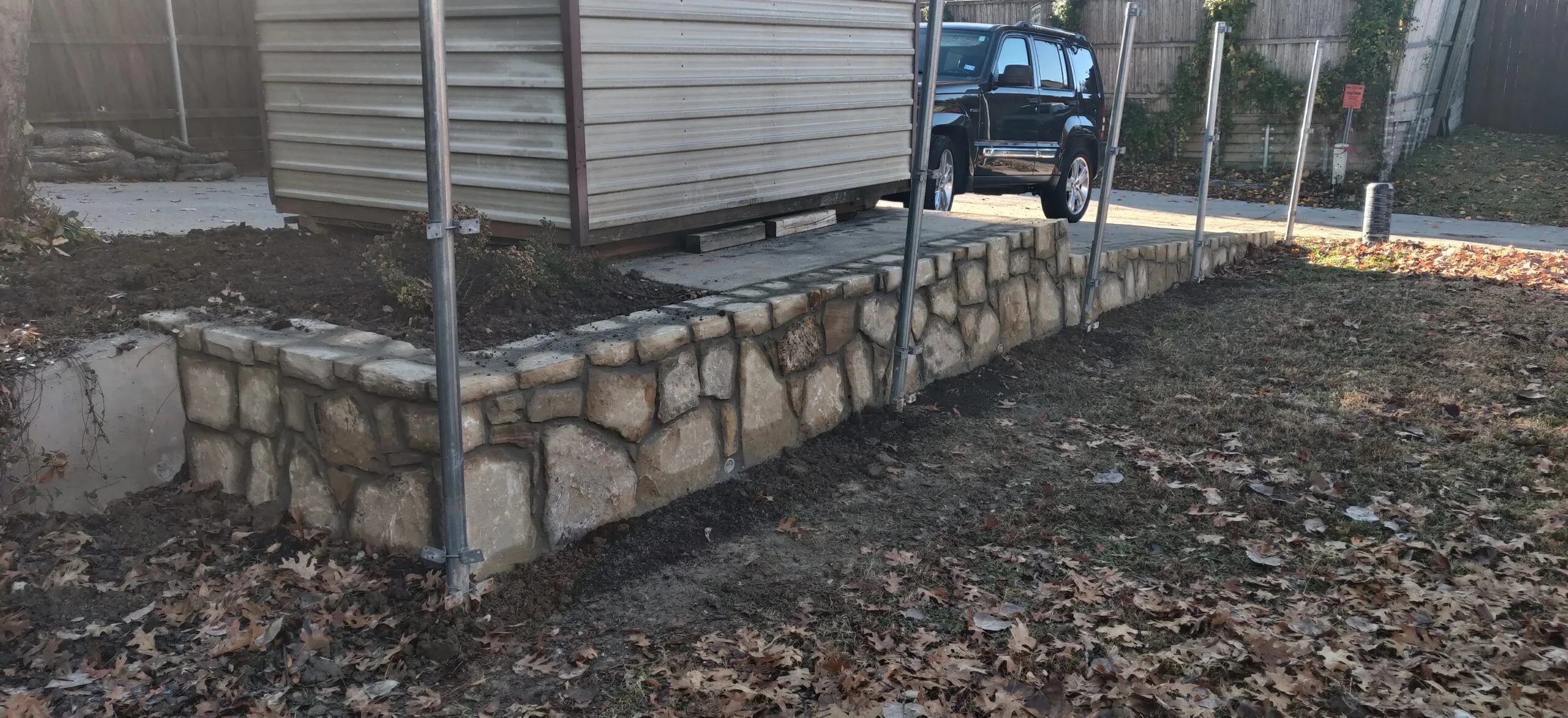 Replaced cross tie retaining wall with Milsap stone in Bedford