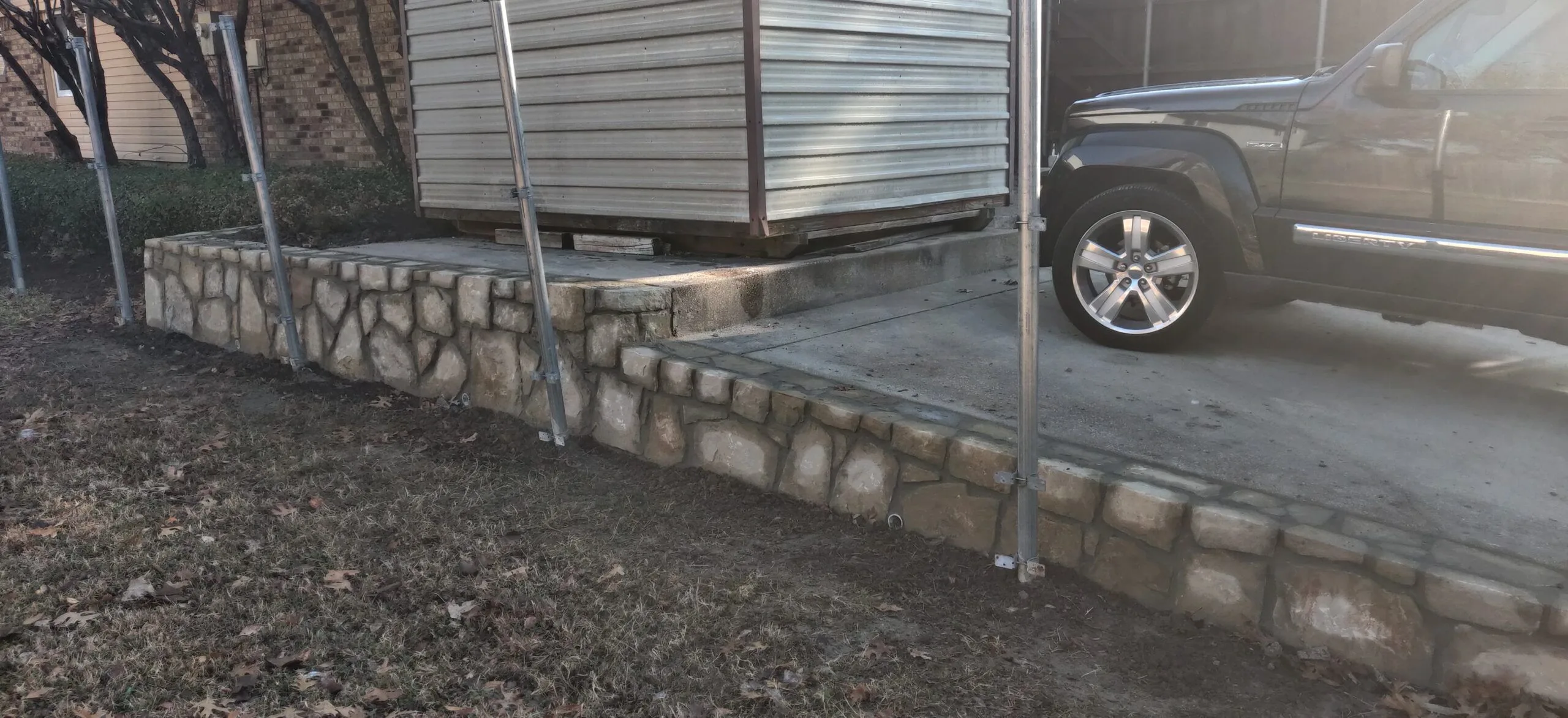 Replaced cross tie retaining wall with Milsap stone in Bedford