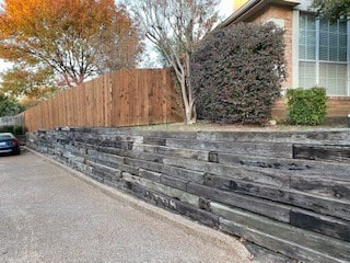 Rename Replaced cross tie wall with Milsap stone wall in Bedford Texas