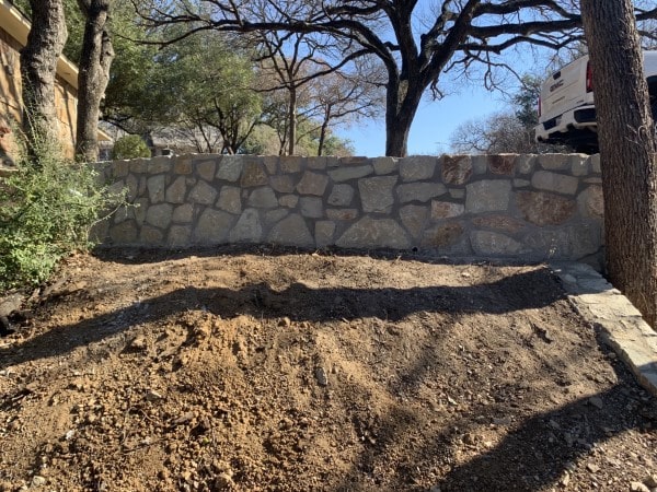 Replaced old crosstie wall with new milsap stone wall in Fort Worth