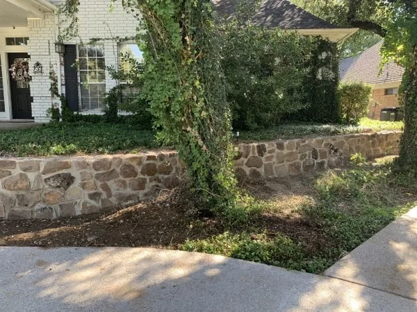 Replaced old block retaining wall with moss rock boulders in Fort Worth (1)-min Replaced old block retaining wall with moss rock boulders in Fort Worth (1)-min
