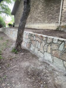 Replaced old failing cinder block wall with new milsap stone in Plano