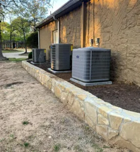 Low Milsap stone retaining wall along home foundation supporting AC units, Highland Village TX