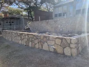 New Milsap stone retaining wall replacing old crosstie wall at a residential property in Hickory Creek TX
