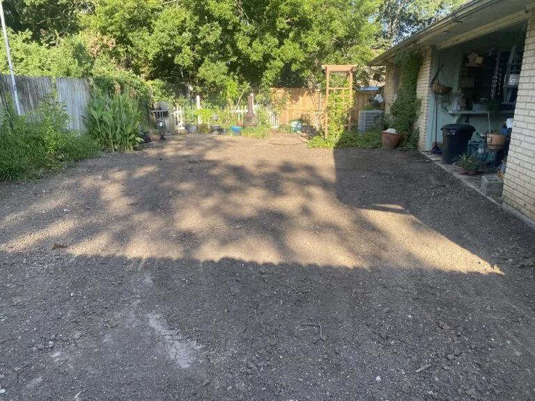 Backfilled, graded backyard after partial pool removal in Arlington TX, leaving flat bare soil ready for new use