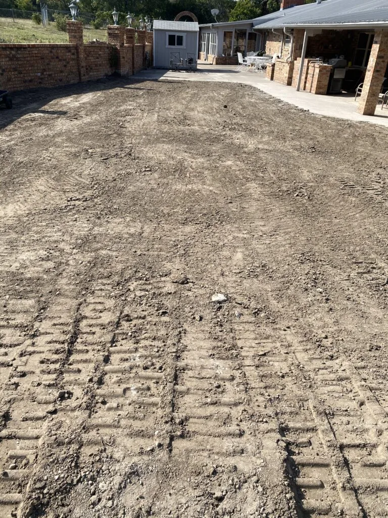 Backfilled and graded backyard after complete pool removal at Fort Worth home, debris cleared and soil compacted ready for new use
