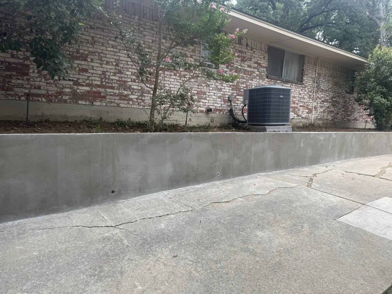 Retaining wall base and drainage under construction in Irving / Las Colinas, TX