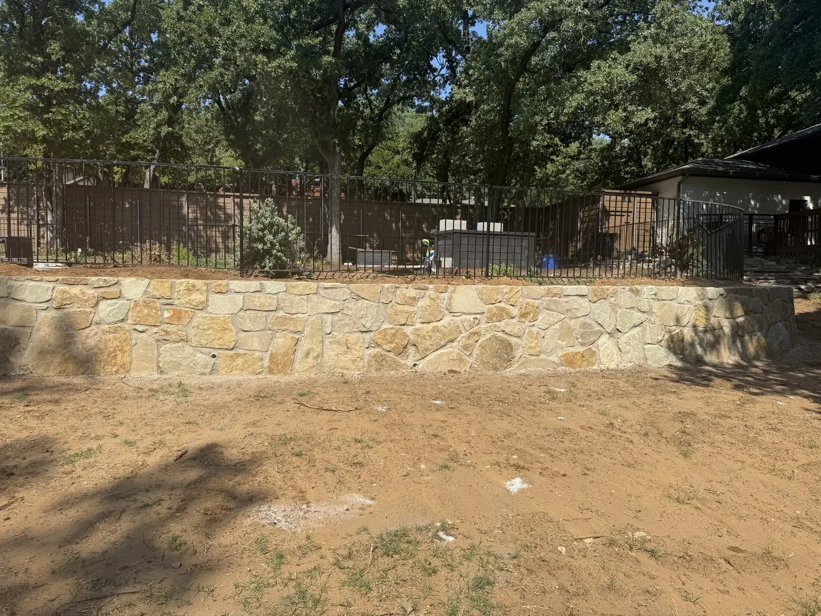 Retaining wall base and drainage under construction in Bartonville, TX