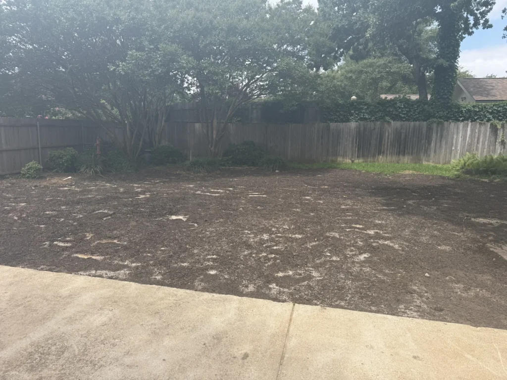 Backyard in Arlington, TX cleared, backfilled and graded level after pool removal by DFW Retaining Walls and Pool Demo