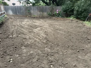 Backyard in Bedford, TX cleared and graded level after pool removal by DFW Retaining Walls and Pool Demo