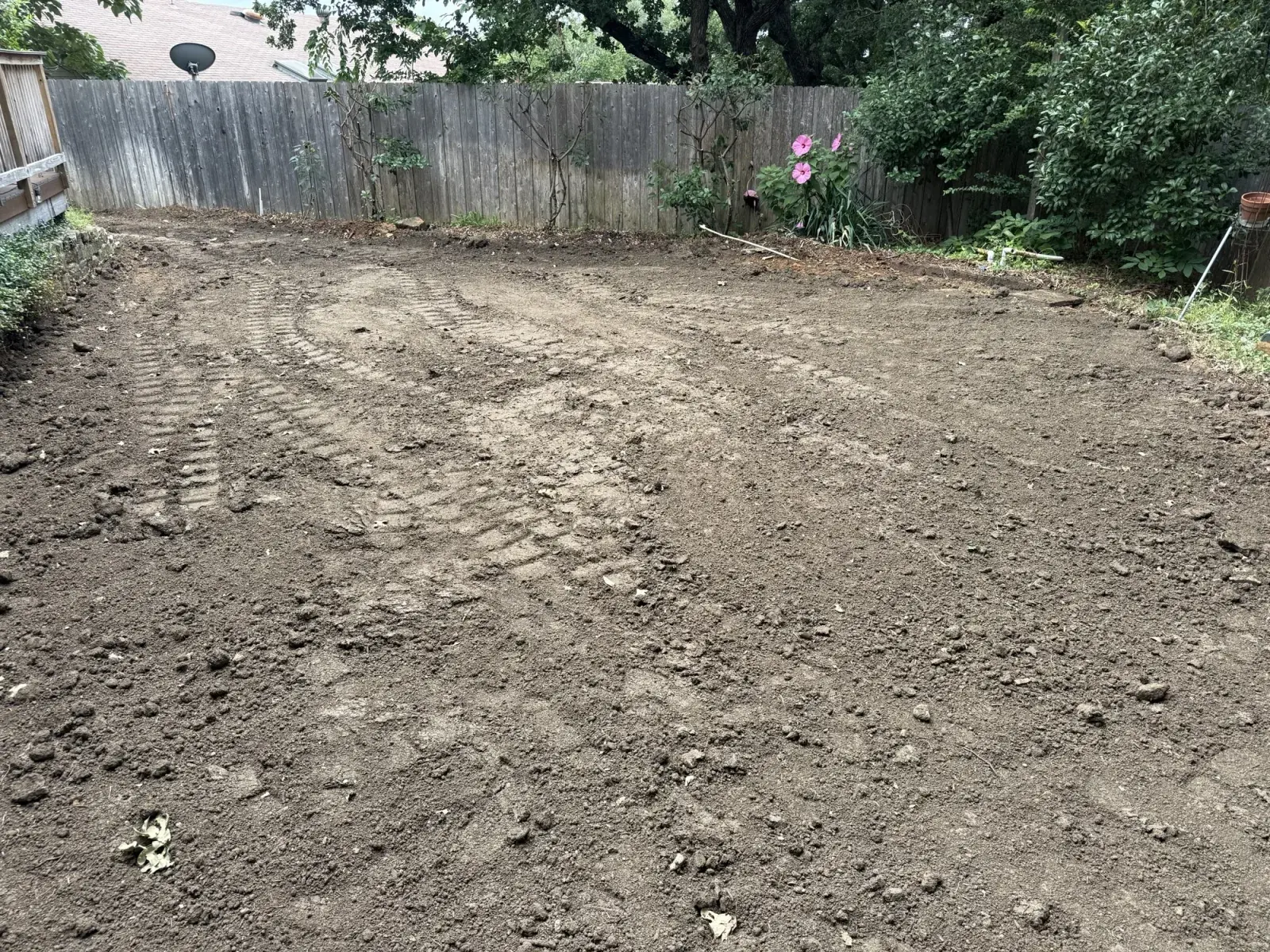 Backyard in Bedford, TX cleared and graded level after pool removal by DFW Retaining Walls and Pool Demo